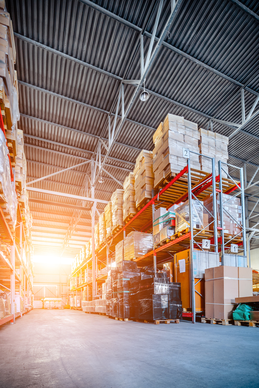 Warehouse industrial and logistics companies. Long shelves with a variety of boxes and containers. Toning the image. Bright sunlight.